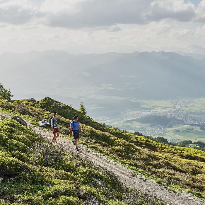 Mountain biker on a trail in a sunny mountain landscape