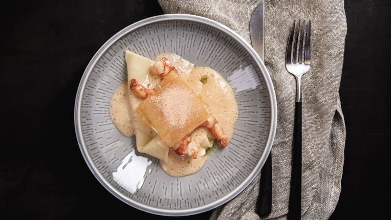 Dining plate with ravioli and shrimp